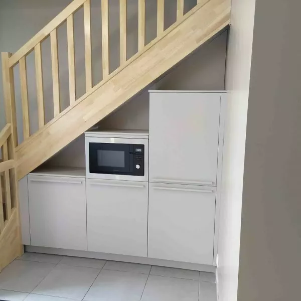 Rangement sous escalier sur mesure, avec micro-ondes encastré