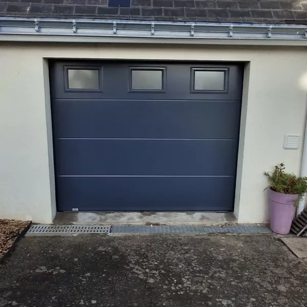 Porte de garage sectionnelle gris anthracite installée en façade